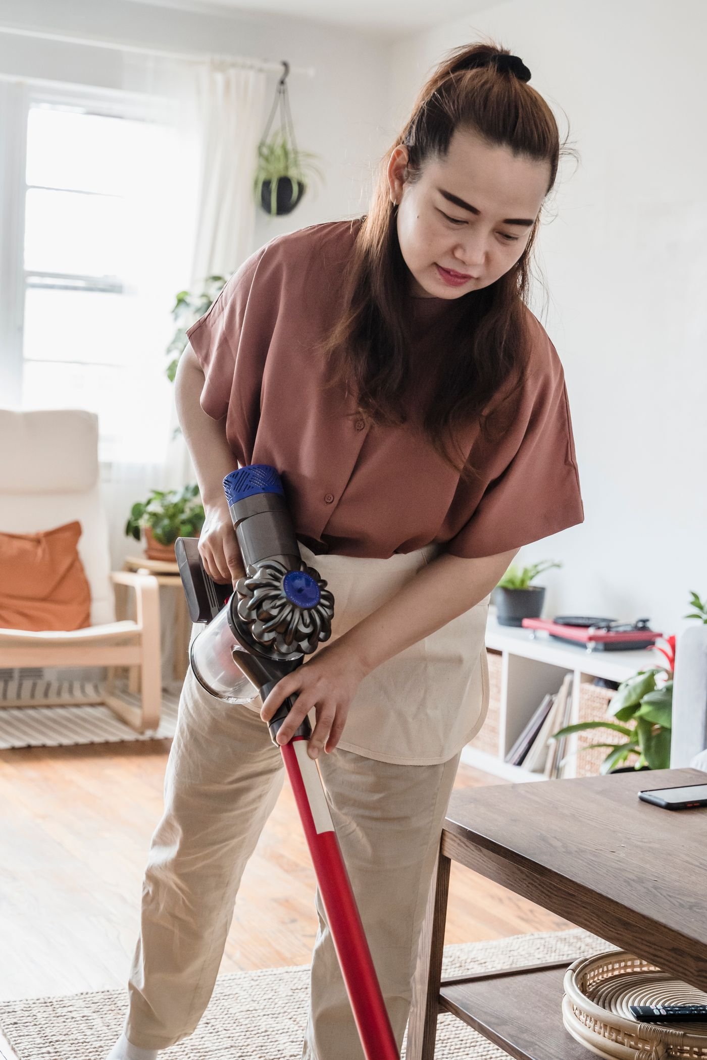 A woman vacuuming a living room